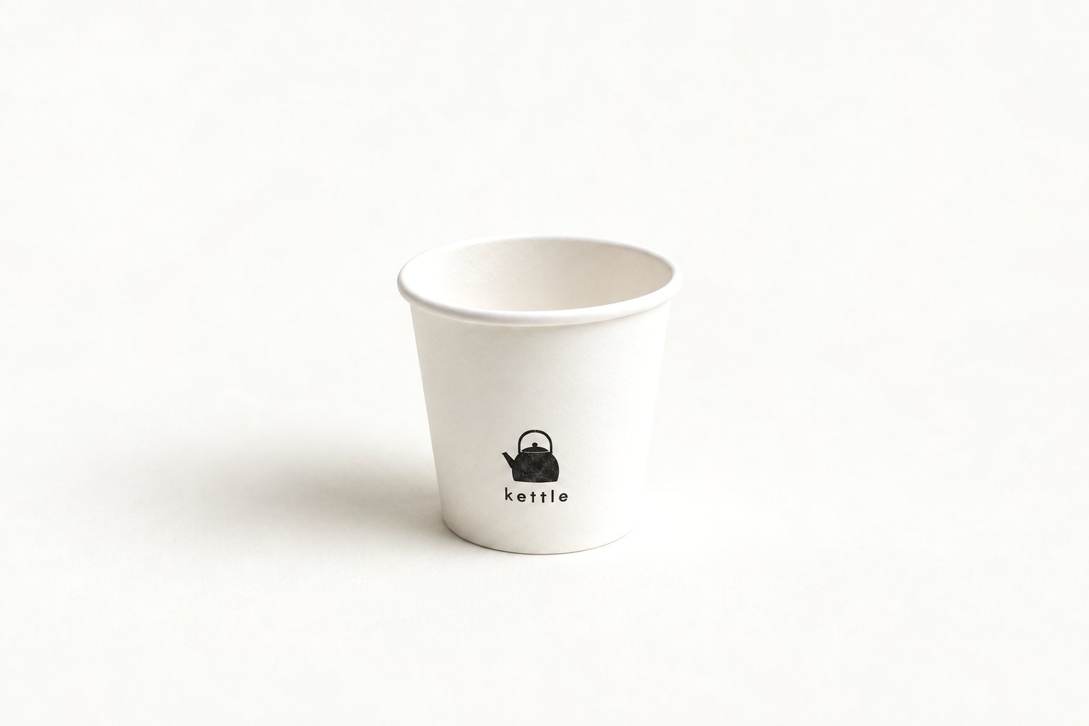 White 4 oz single wall espresso cup printed with a minimalist “kettle” brand design