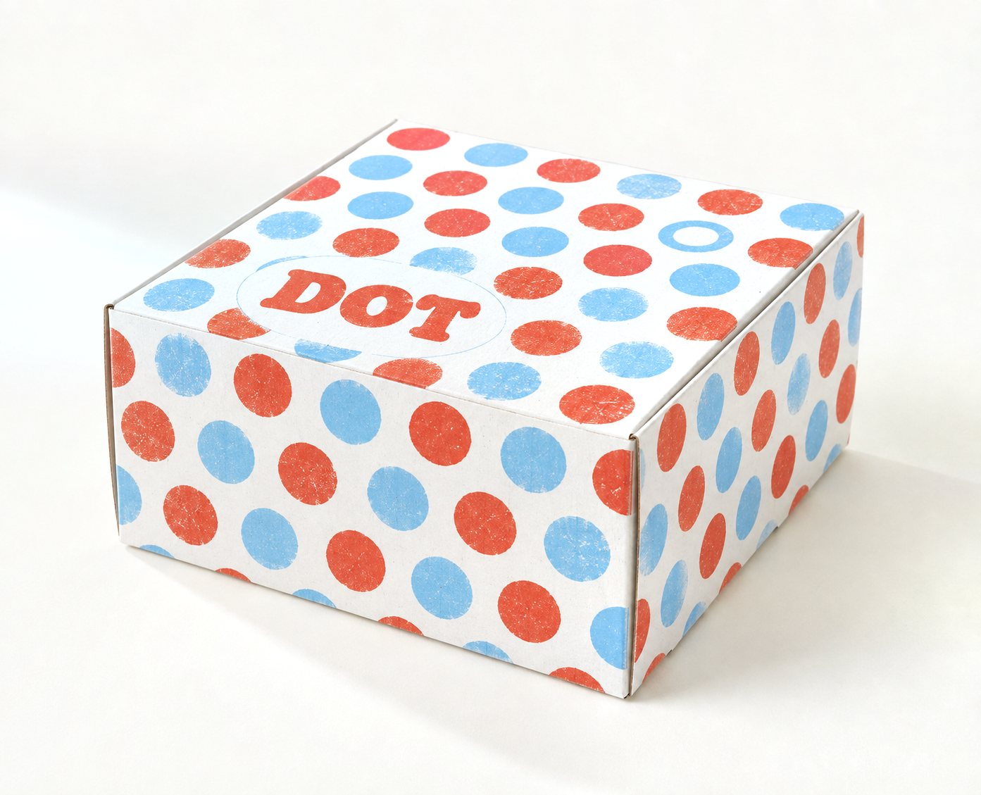 Small kraft cake and pastry box printed with a retro polka-dot pattern and the “DOT” doughnut brand